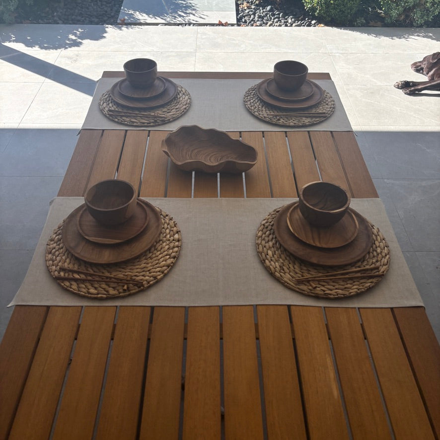 Image shows beige table runner on a set dining table. Hand-woven from 100% sustainable French linen, this table runner adds an earthy elegance and style to your dining table. Dimensions - 110cm x 40cm