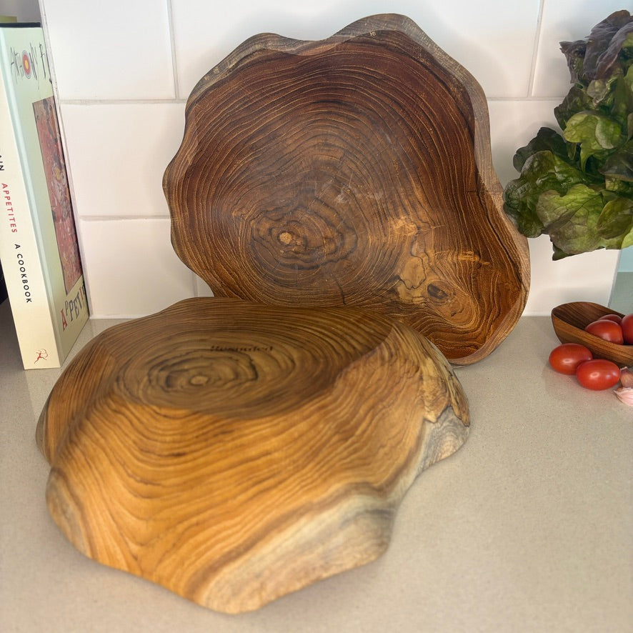 A uniquely shaped bowl, hand-carved from sustainable teak root. Each bowl tells its own story through its intricate grain patterns and organic shape. Perfect for holding fruit, decorative accents, knick-knacks or standing alone as a statement piece. High quality, stylish and durable. Dimensions: 25cm x 25cm x 8cm