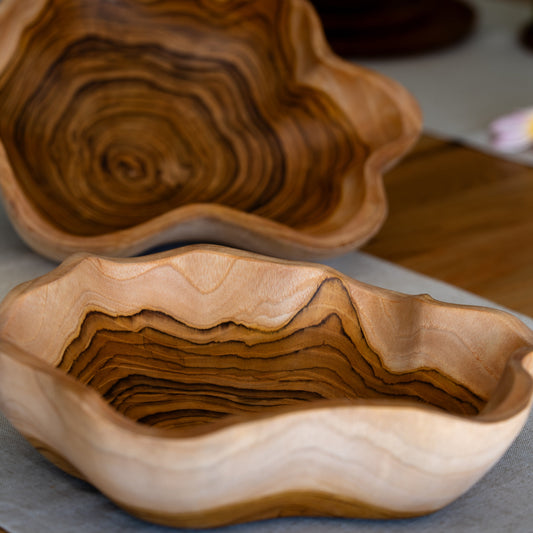 A uniquely shaped bowl, hand-carved from sustainable teak root. Each bowl tells its own story through its intricate grain patterns and organic shape. Perfect for holding fruit, decorative accents, knick-knacks or standing alone as a statement piece. High quality, stylish and durable. Dimensions: 30cm x 25cm x 8cm