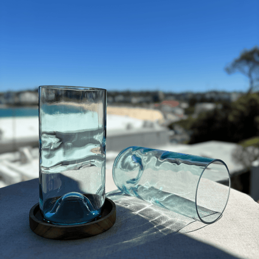 Image of two 550ml up-cycled glass tumblers in clear blue colour, durable and dishwasher safe.