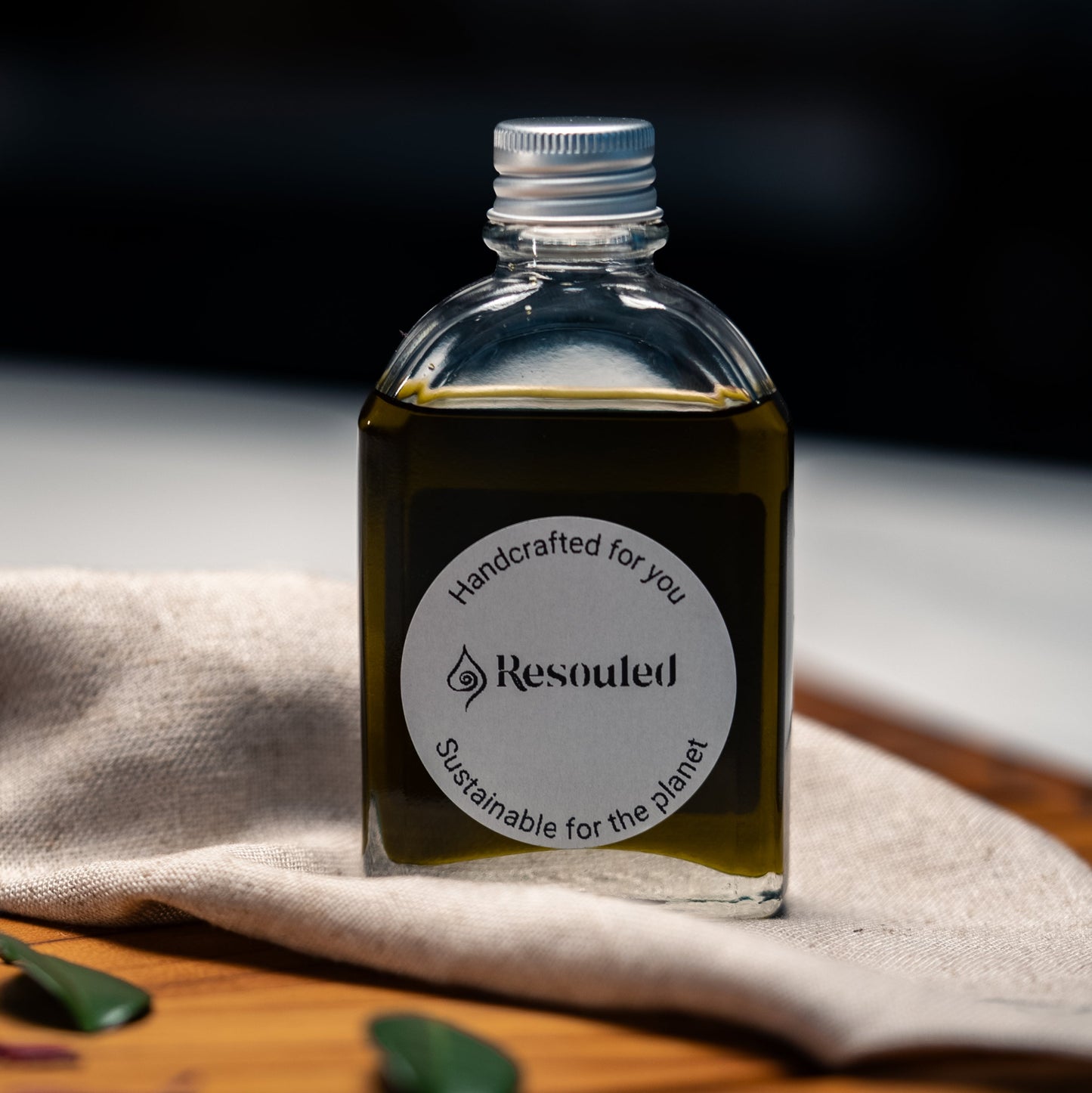 100ml bottle of 100% natural, food safe hemp seed oil in recyclable glass packaging with hemp cloth for application