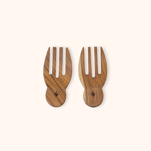 Two teak wooden salad serving hands, made from natural wood with a visible grain pattern, displayed on a solid cream background.