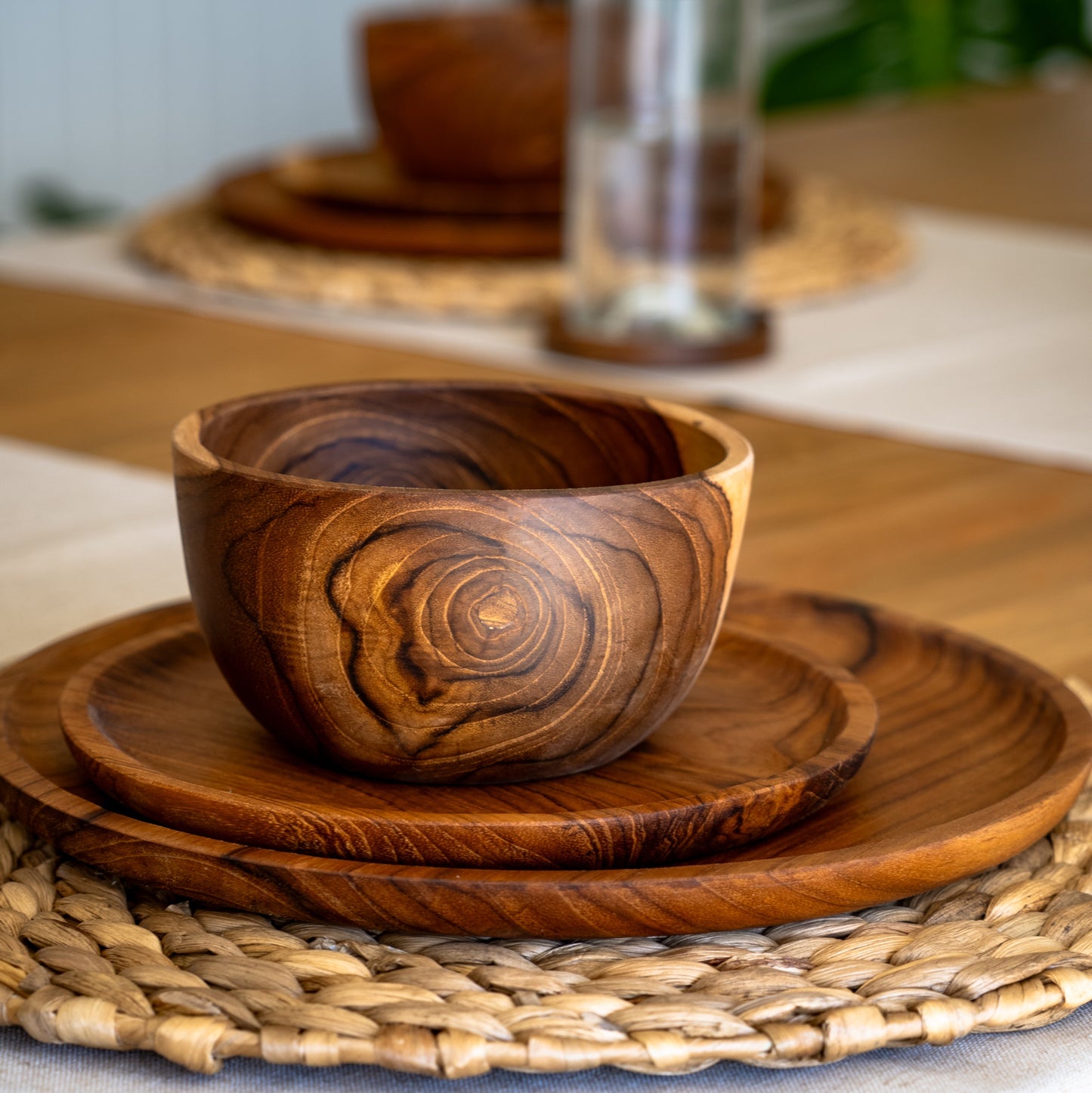 Images shows a stunning trio of handcrafted pieces, comprising a larger plate (28cm x 2cm), smaller plate (20cm x 1.5cm) and a bowl (14cm x 8cm). All pieces are handcrafted from sustainable teak and are as durable as they are stylish.
