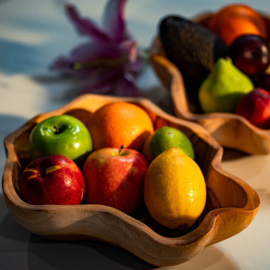 A uniquely shaped bowl, hand-carved from sustainable teak root. Each bowl tells its own story through its intricate grain patterns and organic shape. Perfect for holding fruit, decorative accents, knick-knacks or standing alone as a statement piece. High quality, stylish and durable. Dimensions: 30cm x 25cm x 8cm