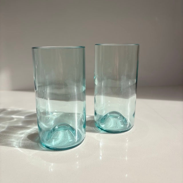 Image of two 550ml up-cycled glass tumblers in clear blue colour, durable and dishwasher safe.
