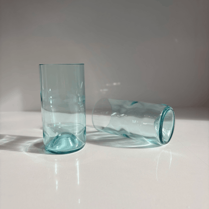 Image of two 550ml up-cycled glass tumblers in clear blue colour, durable and dishwasher safe.