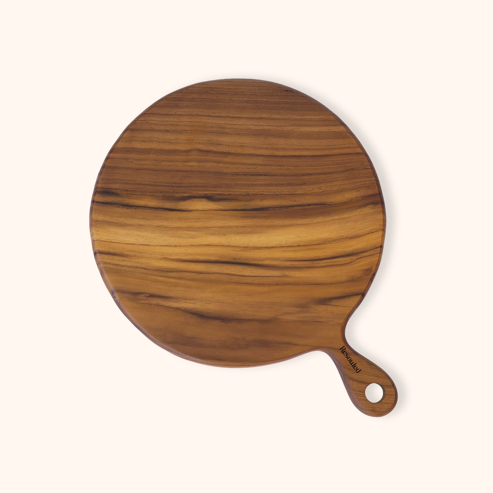 A round teak wooden pizza serving board with a handle, featuring a rich natural wood grain pattern, shown on a solid off-white background.