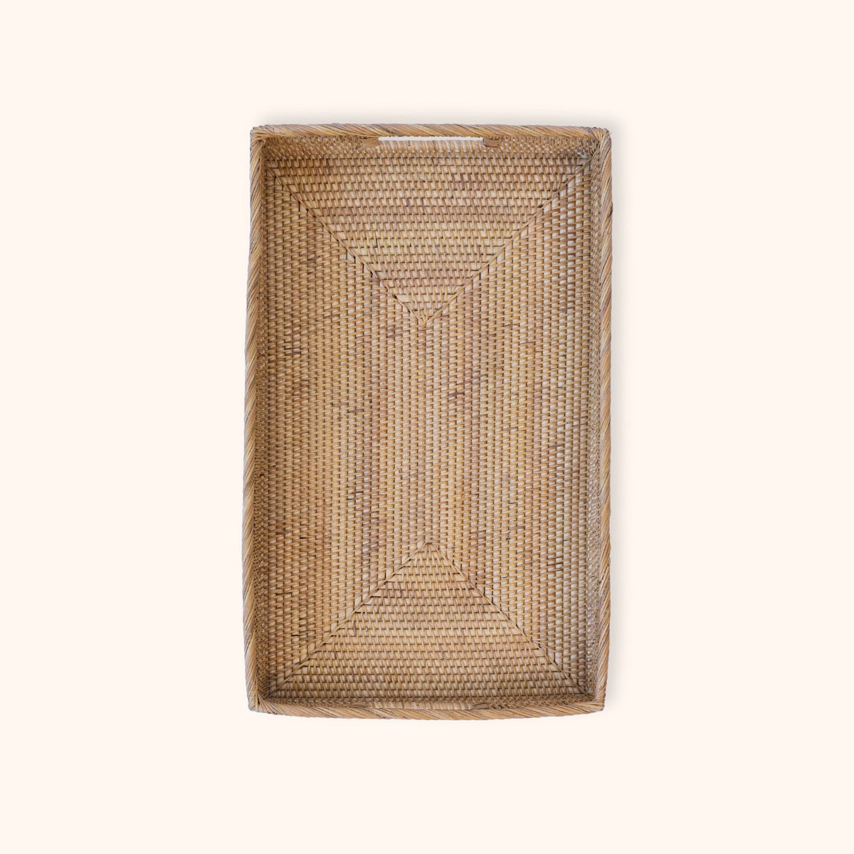 A rectangular rattan woven tray with integrated handles shown from a top-down view on a solid off-white background.