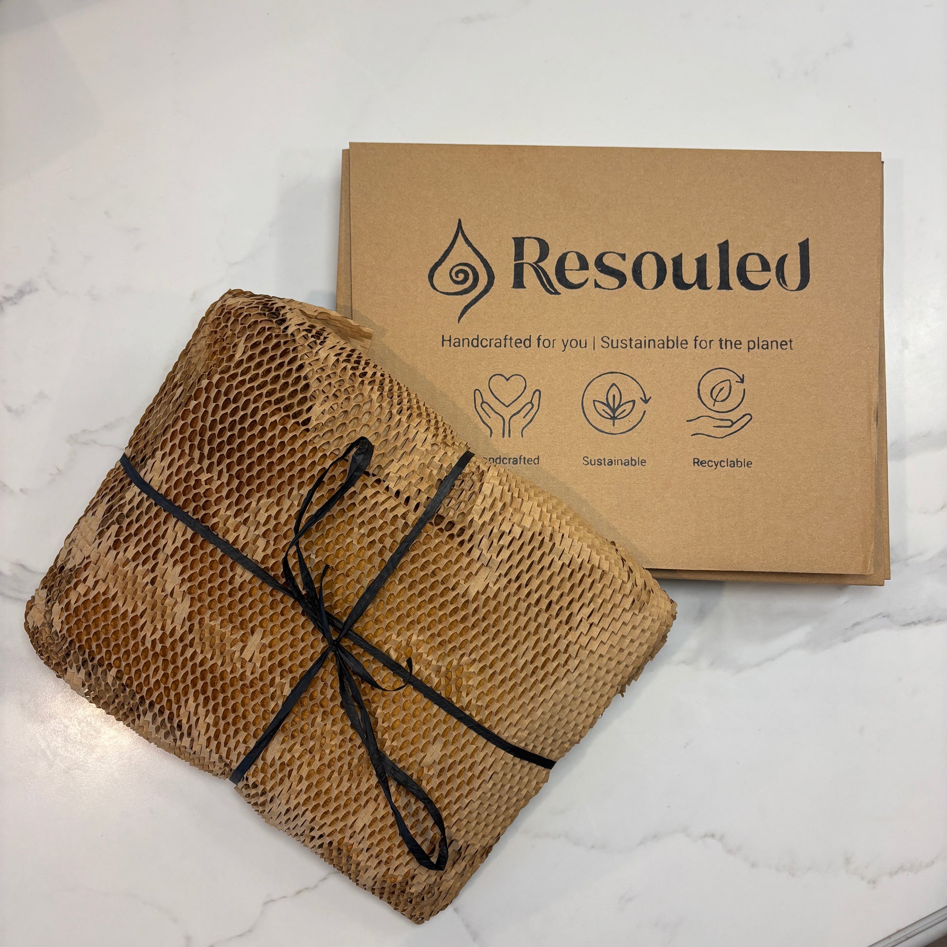 Image showing set of 2 teak chopping boards and sustainable packaging  vs competitor wood fibre board, highlighting plastic-free materials, knife-friendliness, and natural sustainability.