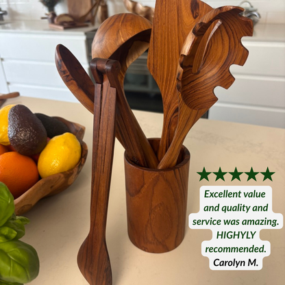 A set of teak kitchen utensils, including a spaghetti spoon, tongs, wooden spoon, ladle and spatula, in a matching wooden holder on a kitchen counter, with a fruit bowl in the background and a 5 star customer review text overlay.