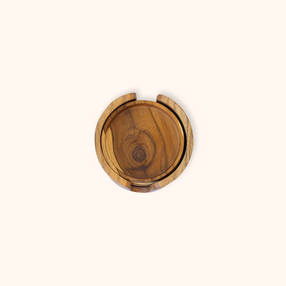 A round teak wooden coaster set with a natural wood grain pattern, shown from a top-down view on a solid off-white background.