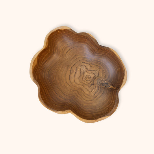 A handcrafted teak wooden bowl with a scalloped edge and a rich, swirling natural wood grain pattern, photographed from directly above on a solid off-white background.