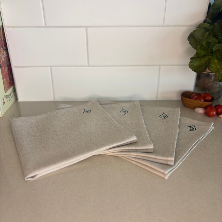 These hand-sown beige napkins are lightweight, breathable and beautifully textured. Each napkin tells a story of thoughtful craftsmanship and sustainable living. Dimensions - 43cm x 43cm.